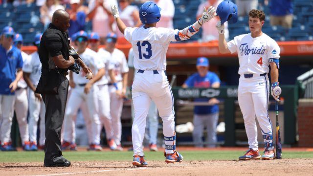 Landon Stripling (left) and Cade Kurland (right) celebrate at home plate after Stripling homered to center field in the sixth inning. (Photo by Ryan Scarane/WRUF)