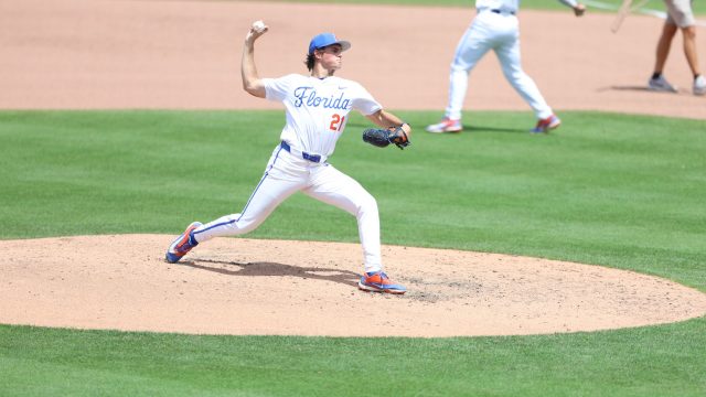 Caden McDonald warms up on the mound before the top of the seventh inning. (Photo by Ryan Scarane/WRUF)