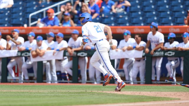 Caden McDonald rounds first base as he watches his eighth inning at-bat clear the wall to bring their deficit to one run. (Photo by Ryan Scarane/WRUF)
