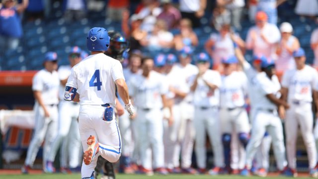 Cade Kurland approaches home plate after a two-run homer as the Florida dugout awaits him to celebrate in the eighth inning. (Photo by Ryan Scarane/WRUF)