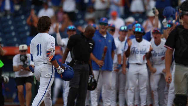 Brendan Lawson steps on home plate to score the game-winning run for the Gators. (Photo by Ryan Scarane/WRUF)