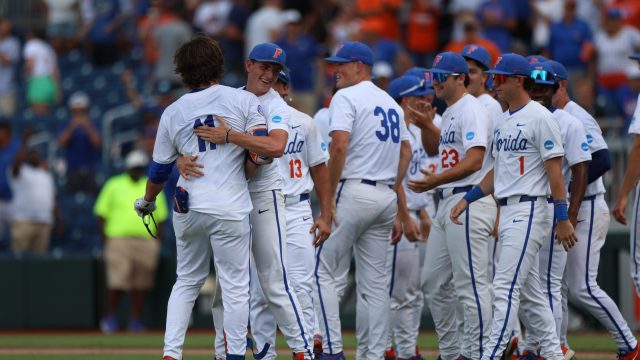 Brendan Lawson exchanges embraces with his teammates after his walk-off homer. (Photo by Ryan Scarane/WRUF)